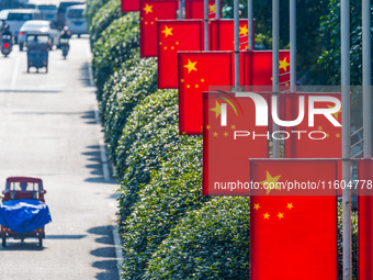 National flags fly along the Golden Buddha Avenue to celebrate the upcoming National Day in Chongqing, China, on September 24, 2024. (