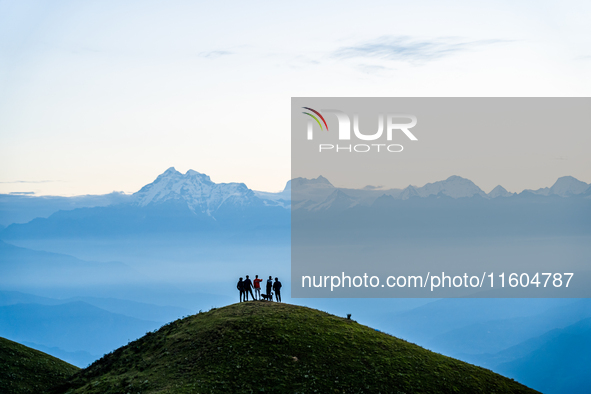 Domestic tourists view the morning scenery of the mountain range from Sailung Hill in Dolakha, Nepal, on September 23, 2024. 