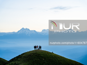 Domestic tourists view the morning scenery of the mountain range from Sailung Hill in Dolakha, Nepal, on September 23, 2024. (