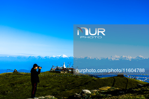 Domestic tourists view the morning scenery of the mountain range from Sailung Hill in Dolakha, Nepal, on September 23, 2024. 