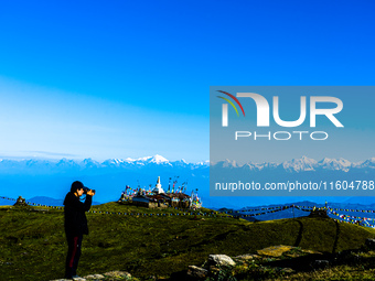 Domestic tourists view the morning scenery of the mountain range from Sailung Hill in Dolakha, Nepal, on September 23, 2024. (