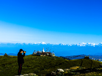 Domestic tourists view the morning scenery of the mountain range from Sailung Hill in Dolakha, Nepal, on September 23, 2024. (