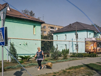 A woman walks along the street in the frontline city of Kurakhove, Pokrovsk district, Donetsk region, eastern Ukraine, on September 16, 2024...