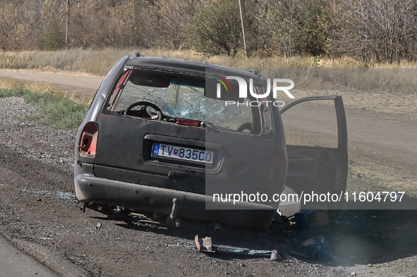 A car of the Ukrainian Armed Forces, hit by an FPV drone of the Russian army, stands on the side of the road towards the town of Vuhledar in...