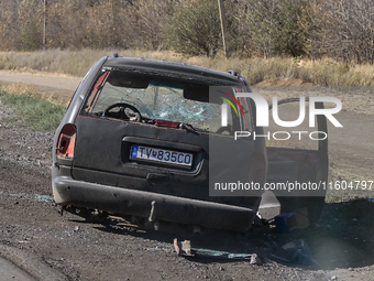 A car of the Ukrainian Armed Forces, hit by an FPV drone of the Russian army, stands on the side of the road towards the town of Vuhledar in...