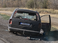 A car of the Ukrainian Armed Forces, hit by an FPV drone of the Russian army, stands on the side of the road towards the town of Vuhledar in...