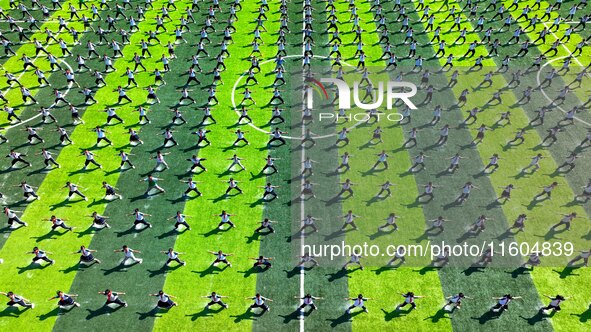 Primary school students practice martial arts during a class break in Tongren, China, on September 24, 2024. 