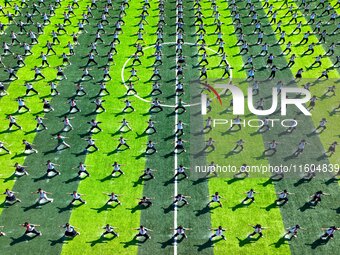 Primary school students practice martial arts during a class break in Tongren, China, on September 24, 2024. (