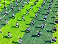 Primary school students practice martial arts during a class break in Tongren, China, on September 24, 2024. (