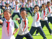 Primary school students practice martial arts during a class break in Tongren, China, on September 24, 2024. (