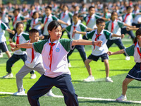 Primary school students practice martial arts during a class break in Tongren, China, on September 24, 2024. (