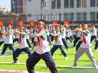 Primary school students practice martial arts during a class break in Tongren, China, on September 24, 2024. (