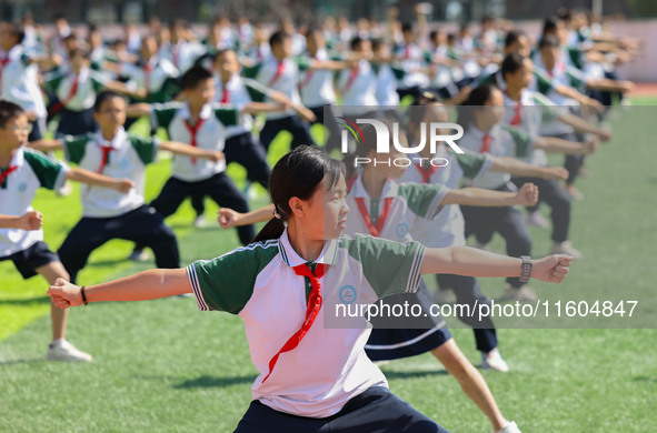 Primary school students practice martial arts during a class break in Tongren, China, on September 24, 2024. 