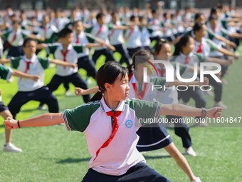 Primary school students practice martial arts during a class break in Tongren, China, on September 24, 2024. (