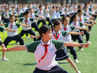 Primary school students practice martial arts during a class break in Tongren, China, on September 24, 2024. (