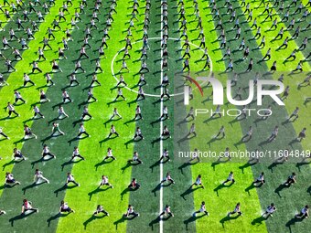 Primary school students practice martial arts during a class break in Tongren, China, on September 24, 2024. (