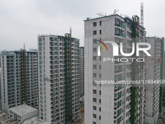 A view from the air shows a newly built commercial housing complex in Hangzhou, China, on September 24, 2024. On the same day, the People's...