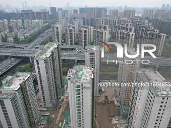 A view from the air shows a newly built commercial housing complex in Hangzhou, China, on September 24, 2024. On the same day, the People's...