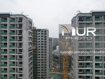 A view from the air shows a newly built commercial housing complex in Hangzhou, China, on September 24, 2024. On the same day, the People's...