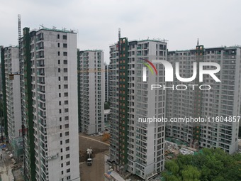 A view from the air shows a newly built commercial housing complex in Hangzhou, China, on September 24, 2024. On the same day, the People's...