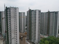 A view from the air shows a newly built commercial housing complex in Hangzhou, China, on September 24, 2024. On the same day, the People's...