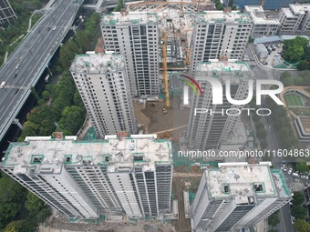 A view from the air shows a newly built commercial housing complex in Hangzhou, China, on September 24, 2024. On the same day, the People's...