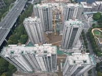 A view from the air shows a newly built commercial housing complex in Hangzhou, China, on September 24, 2024. On the same day, the People's...