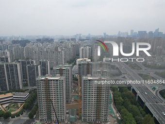 A view from the air shows a newly built commercial housing complex in Hangzhou, China, on September 24, 2024. On the same day, the People's...