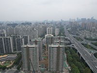 A view from the air shows a newly built commercial housing complex in Hangzhou, China, on September 24, 2024. On the same day, the People's...