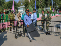 Polling officials carry electronic voting machines (EVM) at a distribution center in Srinagar, Jammu and Kashmir, on September 24, 2024, on...