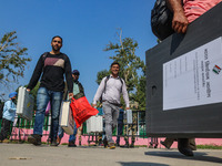 Polling officials carry electronic voting machines (EVM) at a distribution center in Srinagar, Jammu and Kashmir, on September 24, 2024, on...