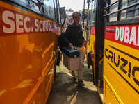 Polling officials carry electronic voting machines (EVM) at a distribution center in Srinagar, Jammu and Kashmir, on September 24, 2024, on...