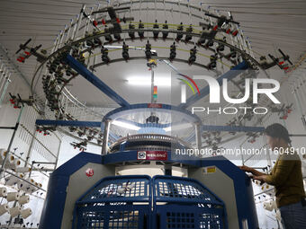 A worker produces products for export at a textile enterprise in Binzhou, China, on September 24, 2024. (