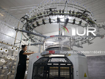 A worker produces products for export at a textile enterprise in Binzhou, China, on September 24, 2024. (