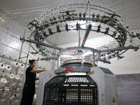 A worker produces products for export at a textile enterprise in Binzhou, China, on September 24, 2024. (