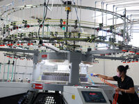 A worker produces products for export at a textile enterprise in Binzhou, China, on September 24, 2024. (