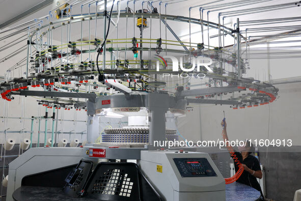 A worker produces products for export at a textile enterprise in Binzhou, China, on September 24, 2024. 