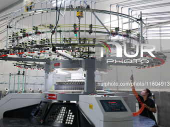 A worker produces products for export at a textile enterprise in Binzhou, China, on September 24, 2024. (