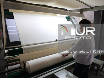 A worker produces products for export at a textile enterprise in Binzhou, China, on September 24, 2024. (