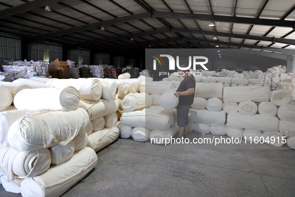 A worker produces products for export at a textile enterprise in Binzhou, China, on September 24, 2024. 