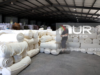 A worker produces products for export at a textile enterprise in Binzhou, China, on September 24, 2024. (