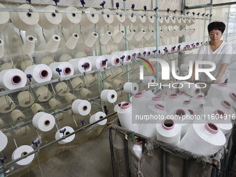 A worker produces products for export at a textile enterprise in Binzhou, China, on September 24, 2024. (