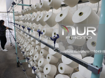 A worker produces products for export at a textile enterprise in Binzhou, China, on September 24, 2024. (