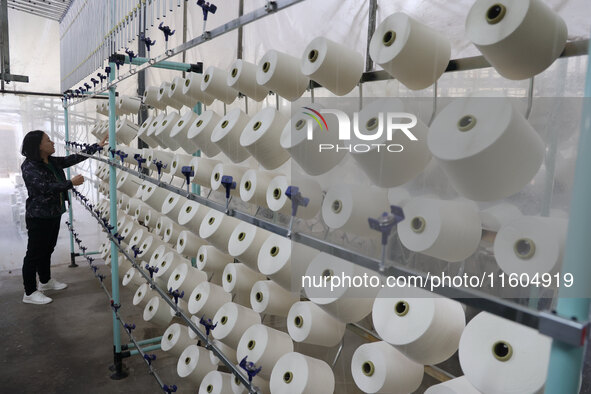 A worker produces products for export at a textile enterprise in Binzhou, China, on September 24, 2024. 