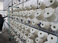 A worker produces products for export at a textile enterprise in Binzhou, China, on September 24, 2024. (