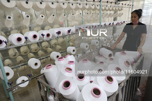 A worker produces products for export at a textile enterprise in Binzhou, China, on September 24, 2024. 