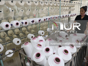 A worker produces products for export at a textile enterprise in Binzhou, China, on September 24, 2024. (