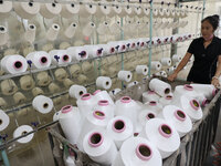 A worker produces products for export at a textile enterprise in Binzhou, China, on September 24, 2024. (