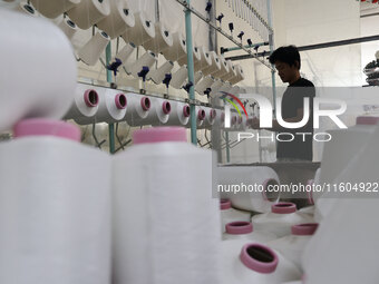 A worker produces products for export at a textile enterprise in Binzhou, China, on September 24, 2024. (