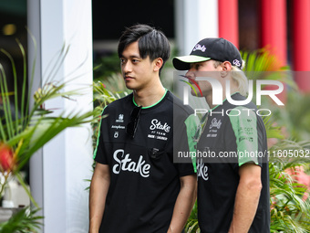 Guanyu Zhou of the Stake F1 Team and Valtteri Bottas of the Stake F1 Team pose with the Sauber C44 during the Formula 1 Singapore Grand Prix...